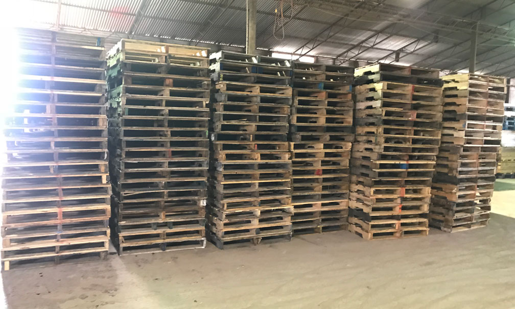 Piles of wood pallets in warehouse
