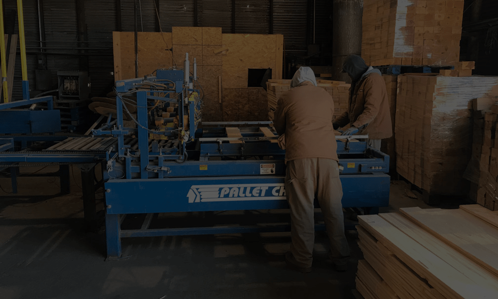 2 men working on building a pallet